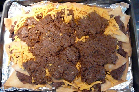 mission tortillas for vegan nachos - flour tortillas deep fried and layered with amy\'s black beans and soy taco meat