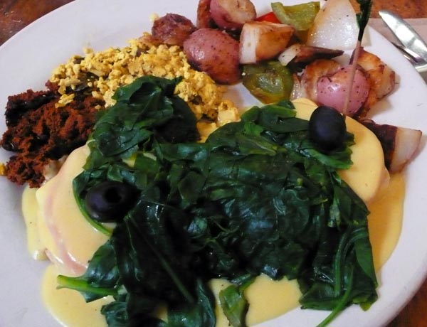 tofu benedict breakfast special: poached tofu and tomato on a toasted english muffin, smothered in an eggless hollandaise sauce. served with breakfast potatoes, soyrizo, scrambled tofu & spinach. $11.95