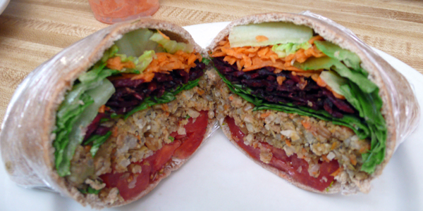 rainforest burger: vegan burger in pita bread with lettuce, carrots, beats spinach and tomato.