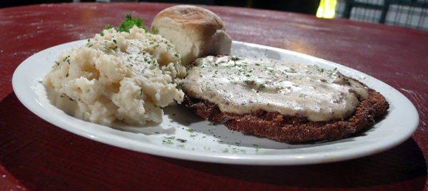 country fried steak: this beefy, breaded bad boy comes smothered in our homemade country gravy! your choice of roasted reds or garlic rosemary mashed potatoes. $9.95