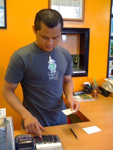 kevin tran, owner of vinh loi tofu wearing a shirt picturing tofu robot, the mascot of quarrygirl.com