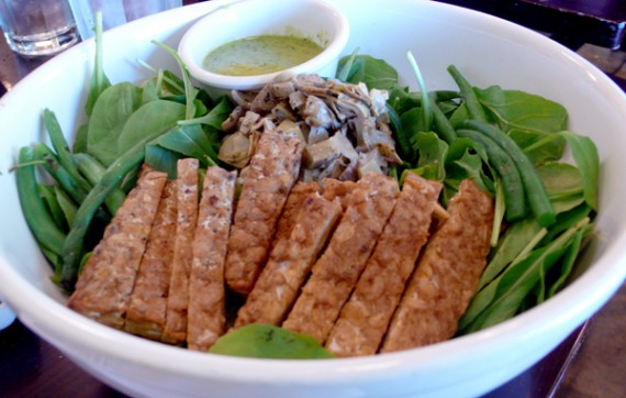 arugula artichoke salad: marinated artichoke hearts and crisp green beans with baby arugula make this salad a green dream. served with lime-cilantro dressing and braised tempeh. $14