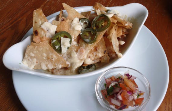 nachos grande (vegan): organic hand fried tortilla chips, jalapeno chillies, melted mature cheddar, and salsa. £3.95