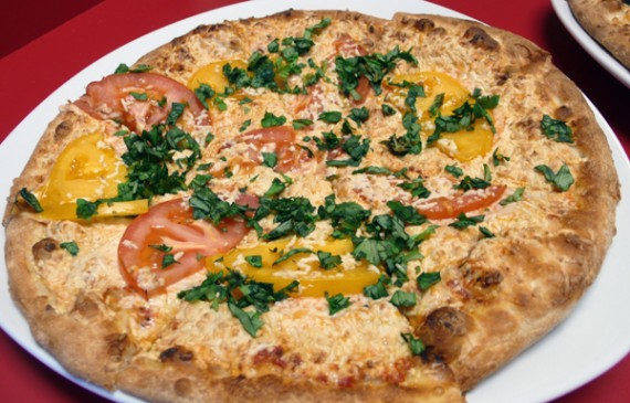 cruzer vegan margherita pizza with red and yellow tomatoes and daiya cheese