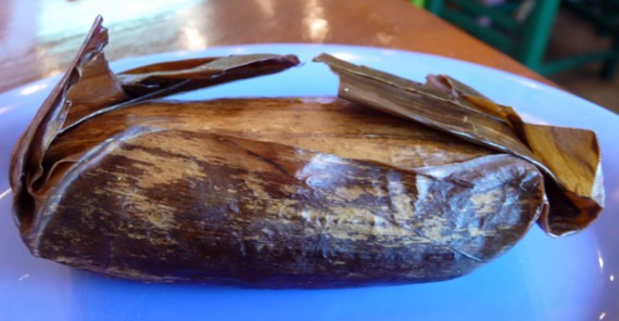 black bean and herb tamale, wrapped in a banana leaf. $2.50