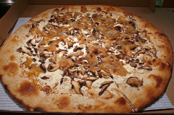 tuscan pizza (veganized): homemade roasted garlic sauce, daiya cheese, cremini, shiitake and button mushrooms, caramelized onions, truffle oil and thyme.