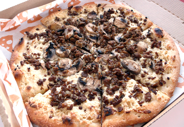 vegan sausage and mushroom pizza with soy crumbles and daiya cheese